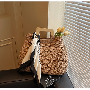 Large woven straw tote bag with square wooden handles and stylish striped scarf detail