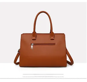 Detail of orange brown tote bag with pebble leather texture and metal zipper pocket
