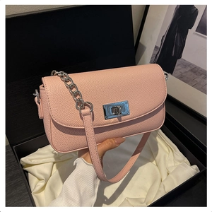 Detailed shot of pink crossbody bag with silver chain strap in luxury gift box packaging