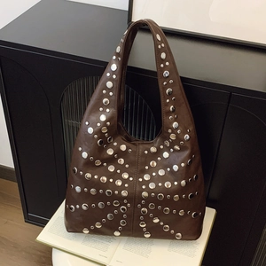 Deep brown leather underarm bag with decorative silver rivets in a vintage aesthetic