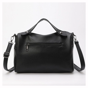Detail of black pebbled PU leather handbag with silver rivets and back zipper pocket