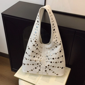 White soft leather Hobo bag with silver studs decoration in a modern minimalist setting