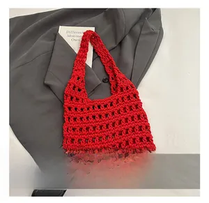 Detail of red hollow knit shoulder bag showing large capacity mesh weave on white background