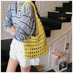 Detail of yellow hollow knit shoulder bag showing mesh texture and large capacity