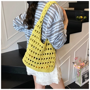 Detail of yellow hollow knit tote bag showing spacious design and crochet shoulder strap