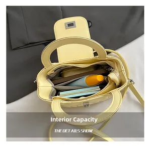 Detail view showing internal capacity of the quilted pale yellow crossbody bag with phone