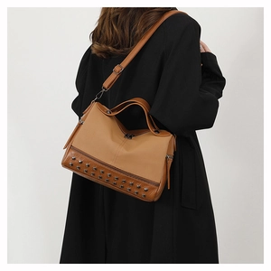 Detail of khaki PU leather tote bag with silver rivets and adjustable shoulder strap