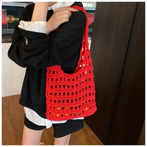 Detail of red hollow knit shoulder bag showing thick crochet cord and mesh texture