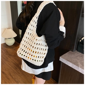 Detail of hollow knit mesh texture and large capacity on beige crochet shoulder bag