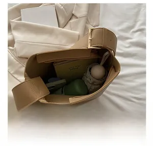 Detail shot of khaki leather tote bag interior showing large capacity for daily items