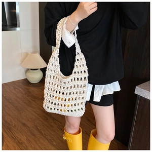 Detailed view of white hollow knit handbag showing high-quality cotton rope mesh texture