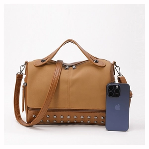 Detail of brown PU leather tote bag with metallic stud base and dual zipper closure system
