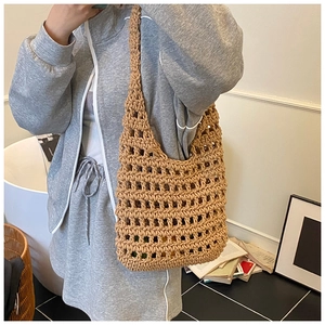 Detail of hand-woven hollow knit tote bag in khaki with large mesh texture