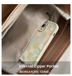 Close-up of internal zipper pocket with herringbone lining in brown leather tote bag