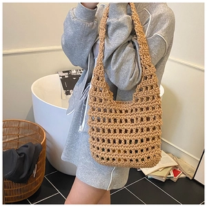Close-up of khaki hollow knit shoulder bag with large mesh texture and U-shape design