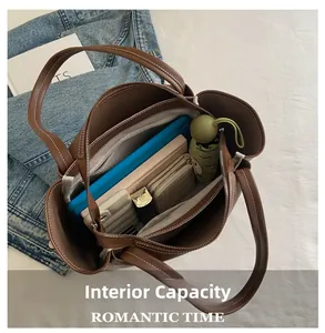 Interior view of brown tote bag showing large capacity for tablets and daily essentials