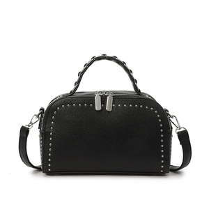 Classic black pebbled leather crossbody bag with silver rivet trim and woven top handle