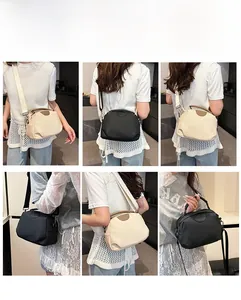 Detail showing versatile carrying ways for the beige and black semi-circular crossbody bag