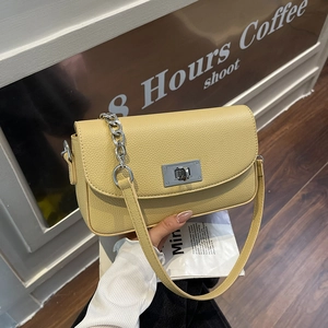 Yellow pebble leather crossbody bag with silver chain strap and metal swivel lock