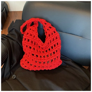 Detail of red hollow knit shoulder bag showing thick cotton rope texture on leather
