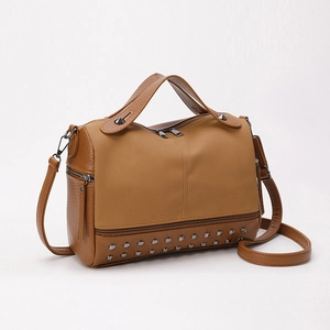 Brown PU leather Boston bag with metal studs and adjustable strap on white background