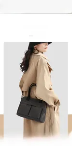 Detailed view of dark grey nylon tote bag with front pockets and black webbing straps