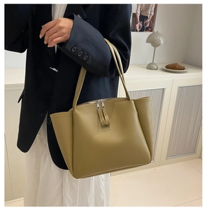 Detail of olive green PU leather tote bag with dual zipper and spacious interior