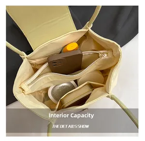 Macro view showing internal capacity with central zipper compartment in light yellow handbag