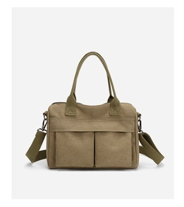 Close-up of khaki canvas tote bag featuring dual front pockets and durable fabric handles
