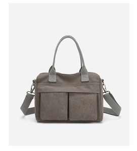 Detail of taupe nylon canvas tote featuring dual front utility pockets and detachable strap
