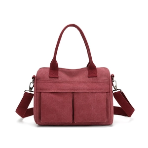 Versatile burgundy nylon canvas tote bag with dual front pockets and adjustable strap