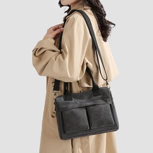Large dark grey nylon tote bag with dual front pockets and adjustable crossbody strap