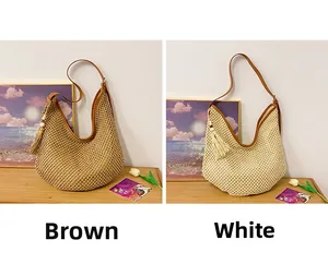 Detail view of woven hollow beach bags in brown and white with leather straps and tassels