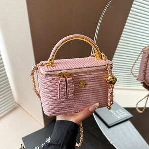 Elegant pink woven mini box bag with gold flower detail and metallic chain strap