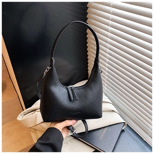 Detailed shot of a black pebbled leather hobo bag showing texture and dual zip closure