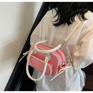 Detail of pink and white faux leather backpack with bow drawstrings and adjustable straps