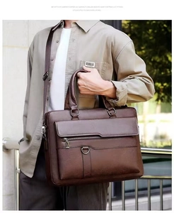 Close-up of brown textured leather briefcase featuring a large flap and metallic D-ring