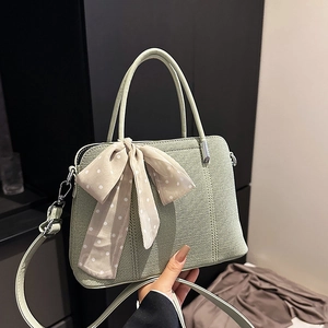 Sac bandoulière chic vert clair tissé avec foulard à pois et finitions argentées
