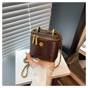 Détails d'un mini sac marron texture serpent avec chaîne dorée et double fermeture éclair