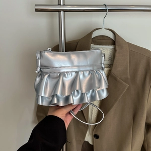 Silver metallic bucket bag with ruffled layers and a stylish slim shoulder strap for women