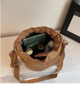 Interior view showing the large capacity and storage space of the canvas crossbody bag