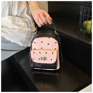 Detail of mini backpack featuring black rabbit patterns and pink pleated fabric detail