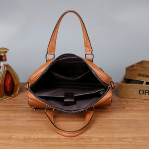 Brown leather business briefcase with interior laptop compartment and pebble texture