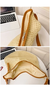 Detail of beige woven tote showing smooth zipper closure and spacious inner pocket