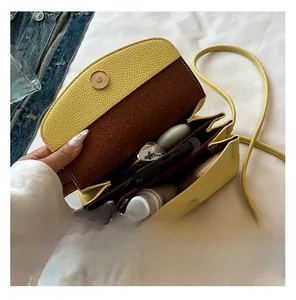 Detail view of the yellow crossbody bag showing internal multi-layer storage capacity