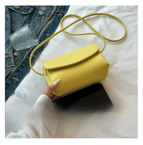 Macro detail of yellow pebble grain leather texture and bag interior with phone