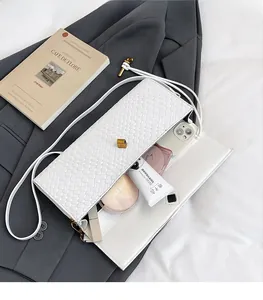 Top view of white woven baguette bag showing spacious interior with daily essentials
