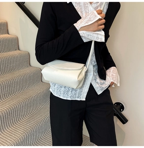 White pebbled leather crossbody bag shown on model for a minimalist daily outfit