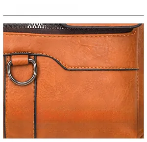 Macro view of brown PU leather bag with lychee texture and metallic D-ring detail