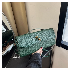 Deep green woven baguette bag with gold metal clasp and detachable strap for women